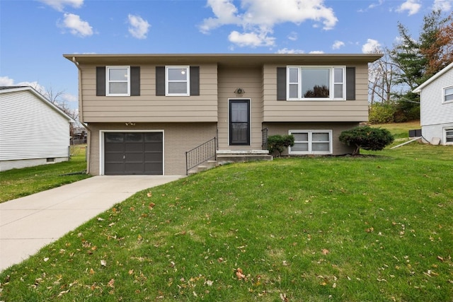 raised ranch with a front yard and a garage