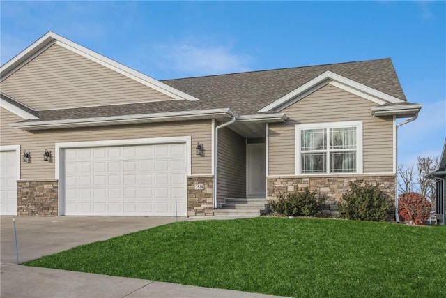 3518 Pioneer Ave SE, Cedar Rapids, IA 52403 - view of front of home featuring an attached garage, a front yard, stone siding, and concrete driveway