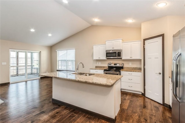 kitchen featuring sink, a center island with sink, appliances with stainless steel finishes, light stone countertops, and white cabinets