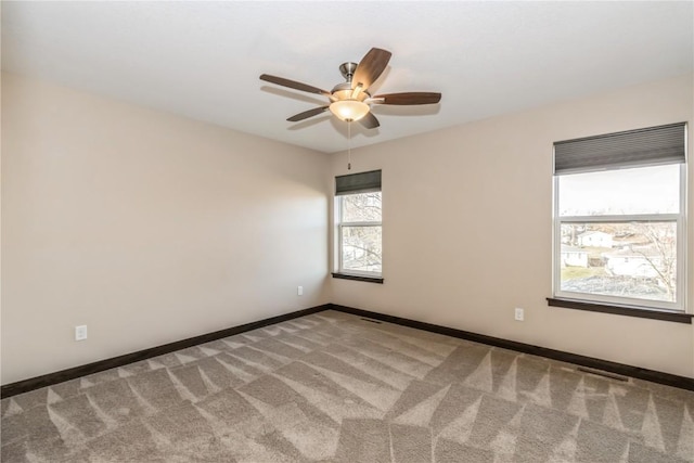 unfurnished room featuring ceiling fan and carpet