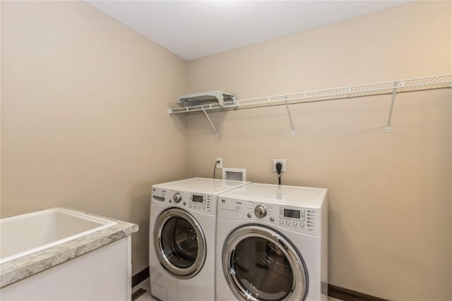 laundry room featuring sink and washing machine and clothes dryer