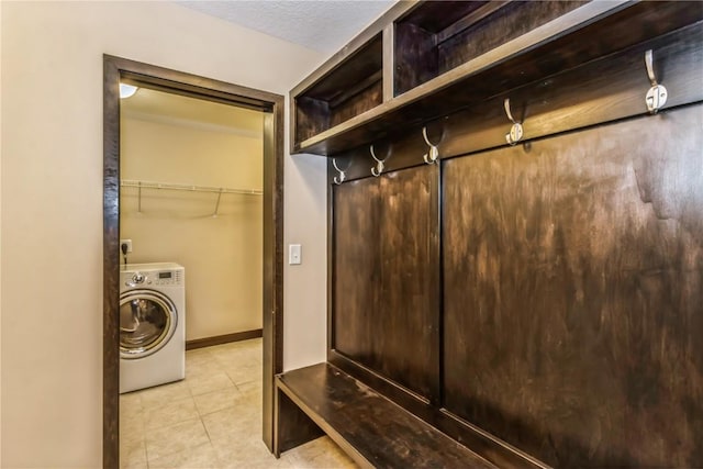 washroom with washer / clothes dryer and light tile patterned floors