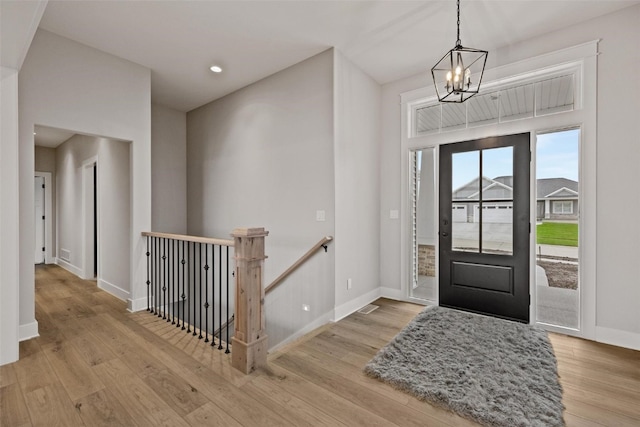 foyer featuring an inviting chandelier and light hardwood / wood-style flooring