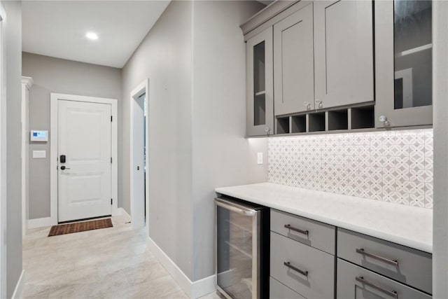 3037 Dell Ridge Ct, Hiawatha, IA 52233 - indoor dry bar featuring wine cooler, decorative backsplash, baseboards, and recessed lighting