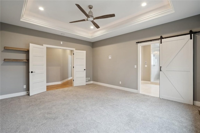 3037 Dell Ridge Ct, Hiawatha, IA 52233 - unfurnished bedroom with a raised ceiling, light carpet, a barn door, recessed lighting, and a ceiling fan