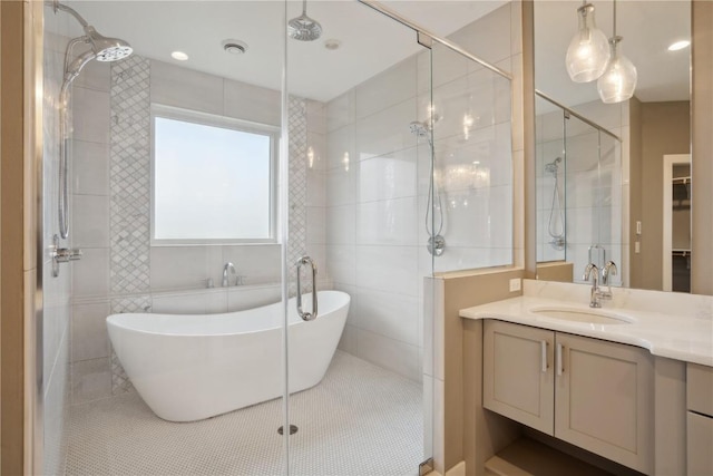 3037 Dell Ridge Ct, Hiawatha, IA 52233 - full bath with a stall shower, vanity, a soaking tub, tile patterned floors, and tile walls