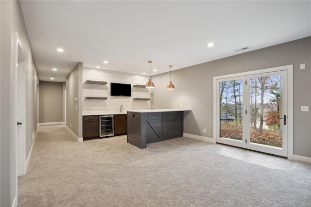 3037 Dell Ridge Ct, Hiawatha, IA 52233 - kitchen with light colored carpet, recessed lighting, baseboards, wine cooler, and light countertops