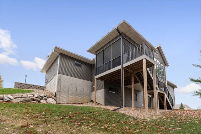 3037 Dell Ridge Ct, Hiawatha, IA 52233 - back of property featuring stairs, a sunroom, and a wooden deck
