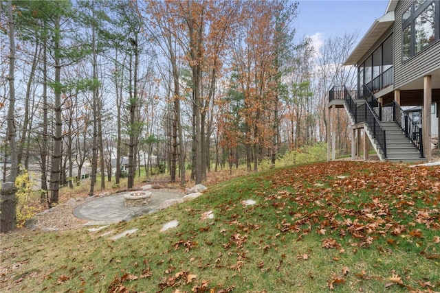 3037 Dell Ridge Ct, Hiawatha, IA 52233 - view of yard with stairway, a fire pit, and a patio