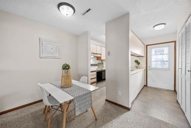 dining area featuring a textured ceiling