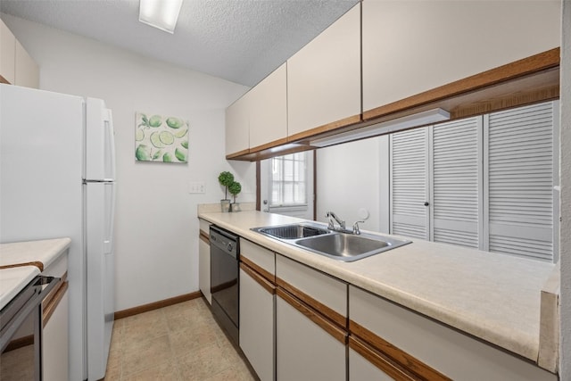 kitchen featuring a textured ceiling, sink, dishwasher, white cabinets, and white fridge