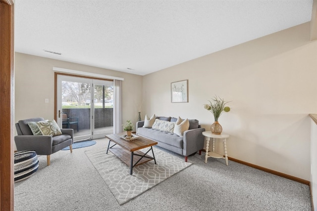 carpeted living room with a textured ceiling