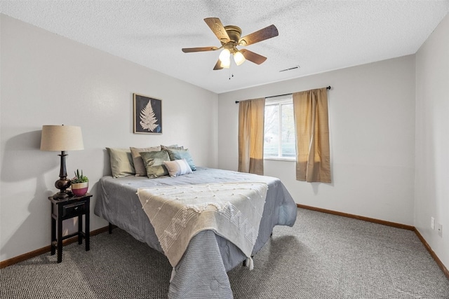 carpeted bedroom featuring a textured ceiling and ceiling fan