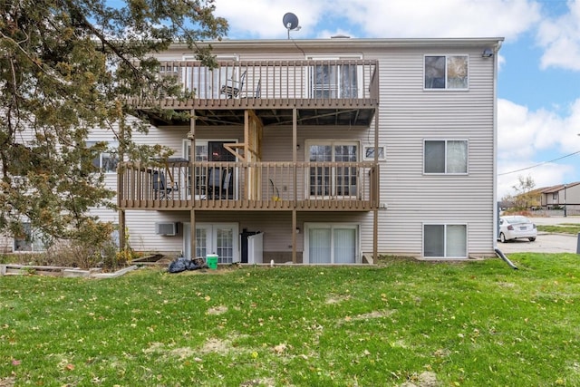 rear view of property with a lawn and a wall mounted AC