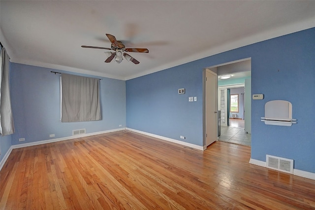 unfurnished room featuring light wood-type flooring and ceiling fan