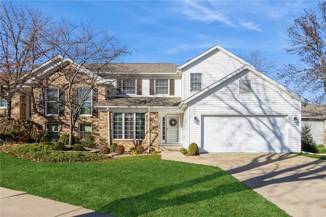 traditional-style house with concrete driveway, an attached garage, and a front lawn