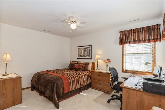 bedroom with ceiling fan and light carpet