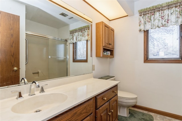 bathroom featuring vanity, toilet, and a shower with door