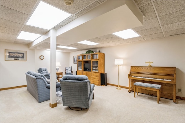 carpeted living room with a paneled ceiling