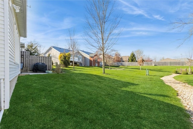 view of yard featuring fence and a residential view