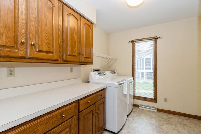 laundry room featuring visible vents, independent washer and dryer, cabinet space, and baseboards