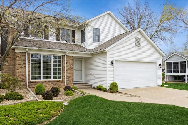 traditional home with a front lawn, a shingled roof, brick siding, concrete driveway, and an attached garage