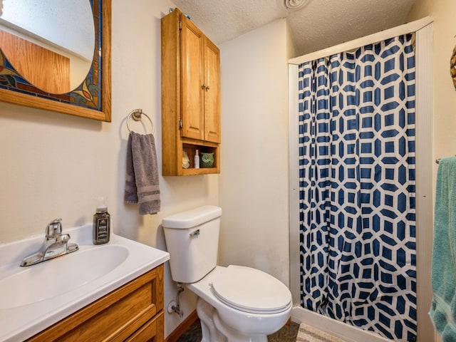 bathroom with vanity, a textured ceiling, toilet, and walk in shower