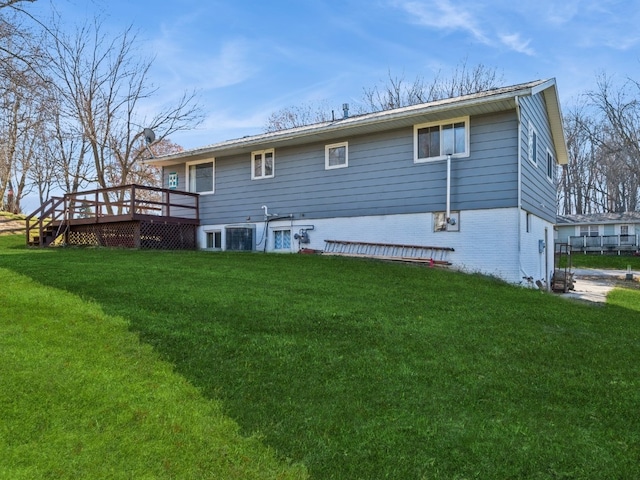 back of property with a deck and a lawn