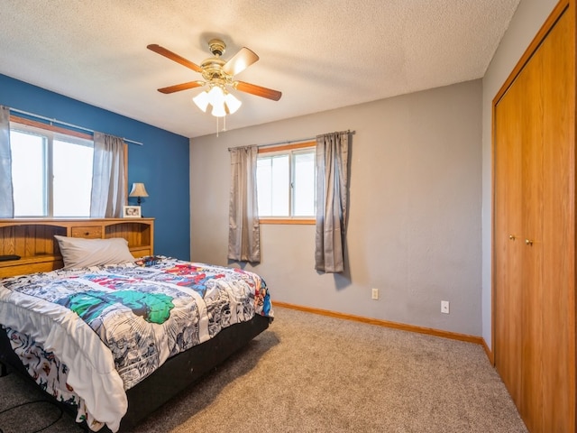 bedroom with multiple windows, ceiling fan, and a closet