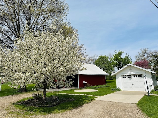 exterior space with an outbuilding and a garage