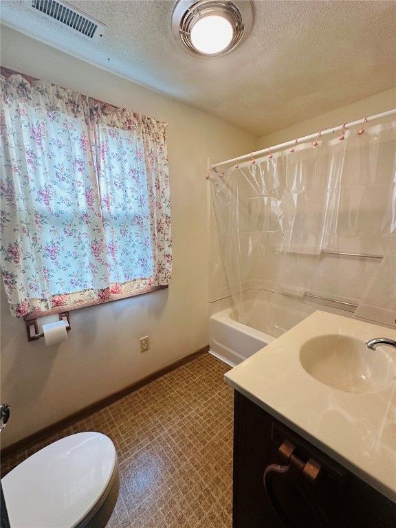 full bathroom featuring shower / bath combo, toilet, a textured ceiling, and vanity