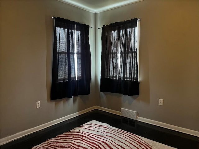 202 N Williams St, Anamosa, IA 52205 - empty room featuring baseboards and dark wood finished floors