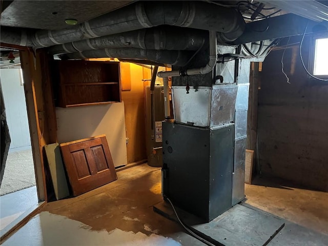 202 N Williams St, Anamosa, IA 52205 - utility room featuring water heater and heating unit