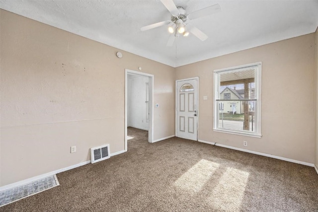 unfurnished room with ceiling fan and carpet floors