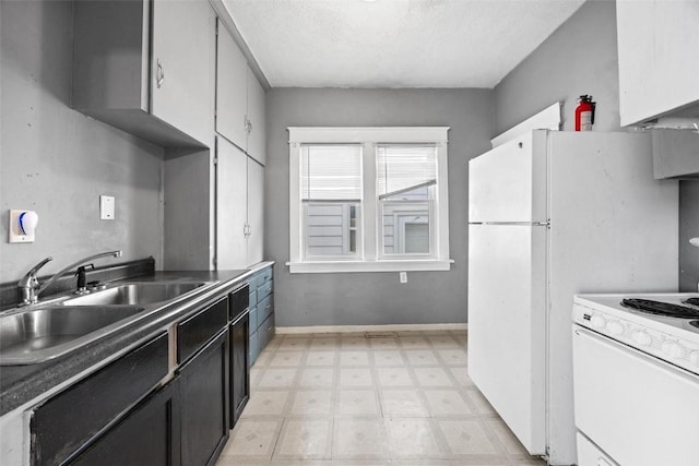 kitchen featuring white range oven, sink, and a textured ceiling