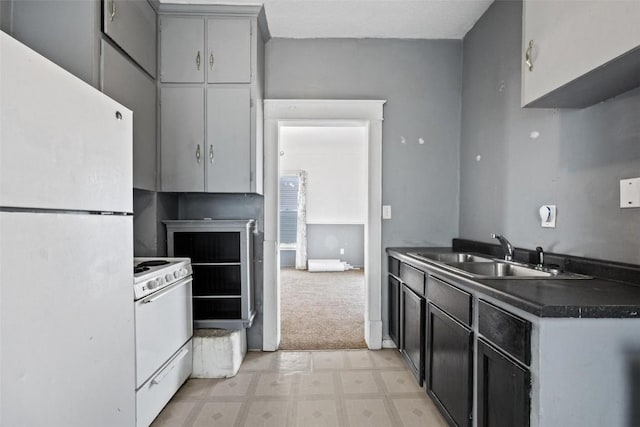 kitchen with light carpet, white appliances, gray cabinets, and sink