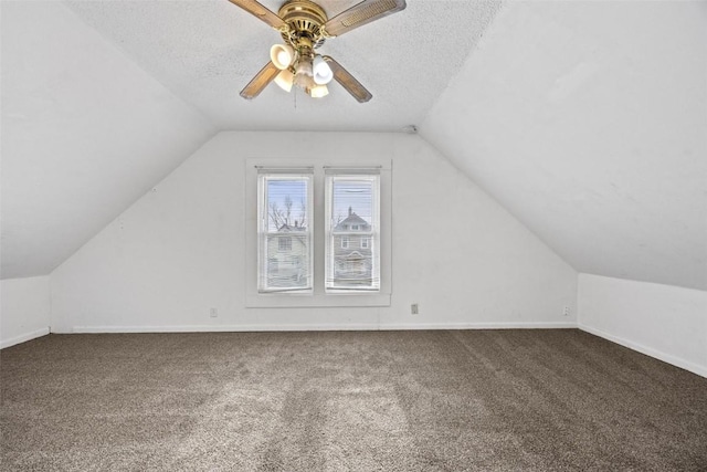 bonus room featuring carpet flooring, ceiling fan, a textured ceiling, and vaulted ceiling