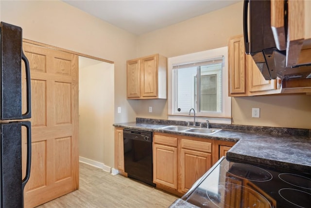 kitchen featuring dark countertops, light brown cabinets, a sink, black appliances, and baseboards