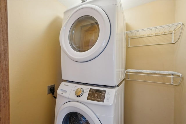 clothes washing area with laundry area and stacked washer / drying machine