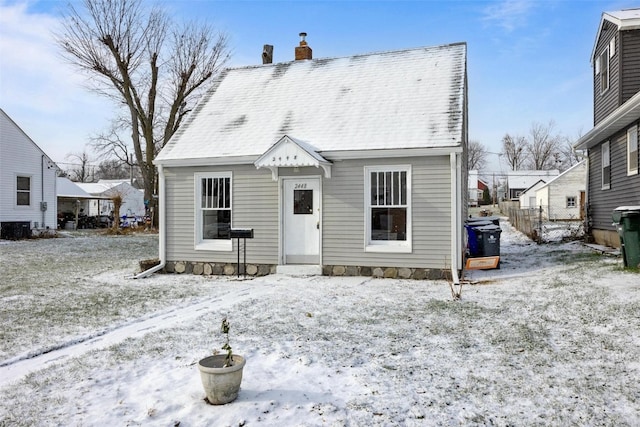 view of snow covered rear of property