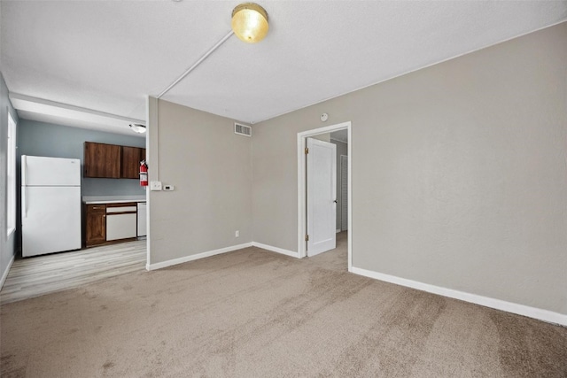 unfurnished living room with light colored carpet