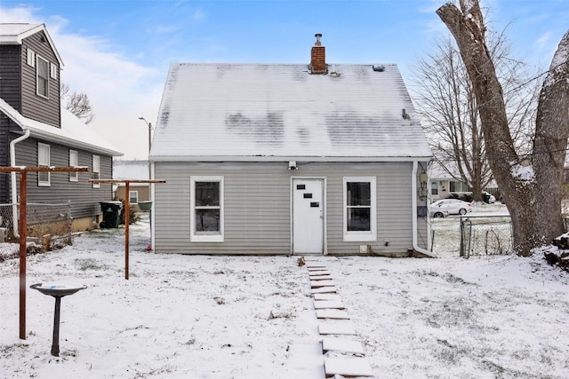 view of snow covered back of property