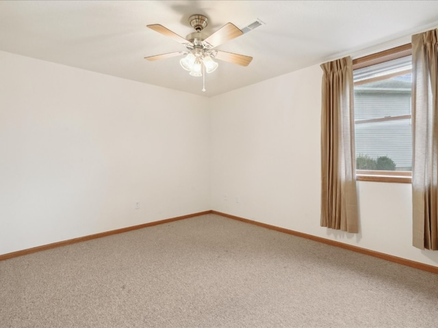 carpeted spare room with ceiling fan