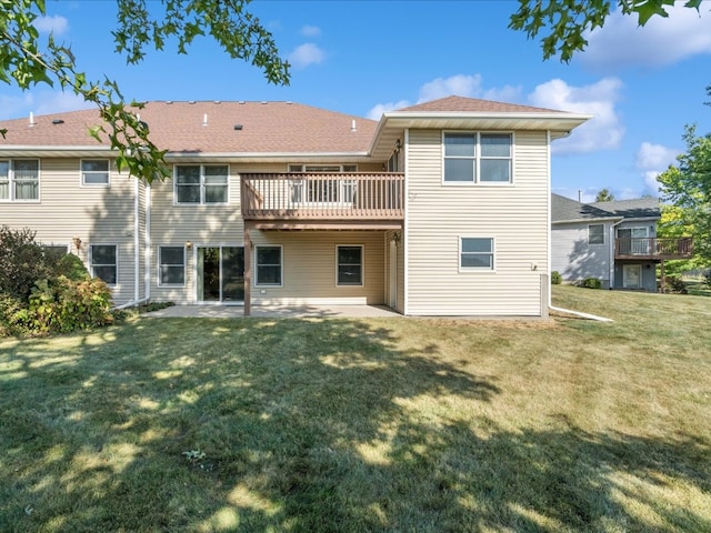 rear view of property with a patio area, a yard, and a deck