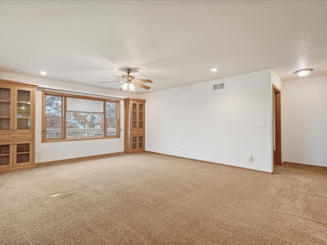 unfurnished living room with carpet flooring and ceiling fan