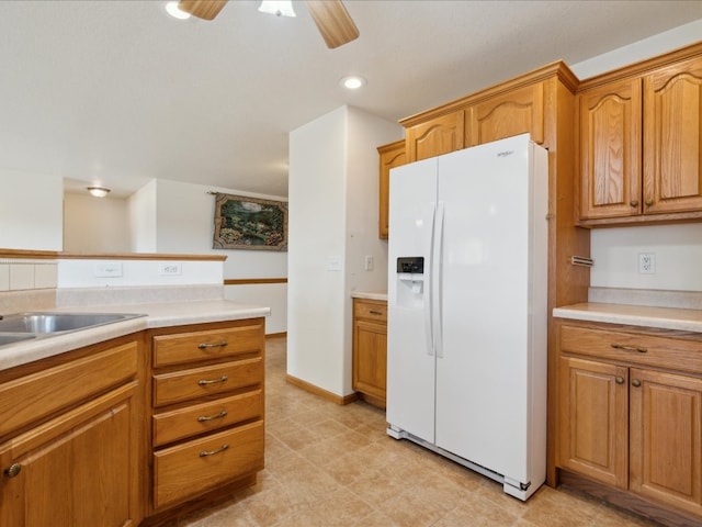 kitchen with white refrigerator with ice dispenser and ceiling fan