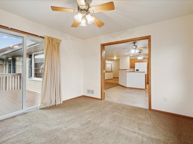 carpeted spare room featuring ceiling fan