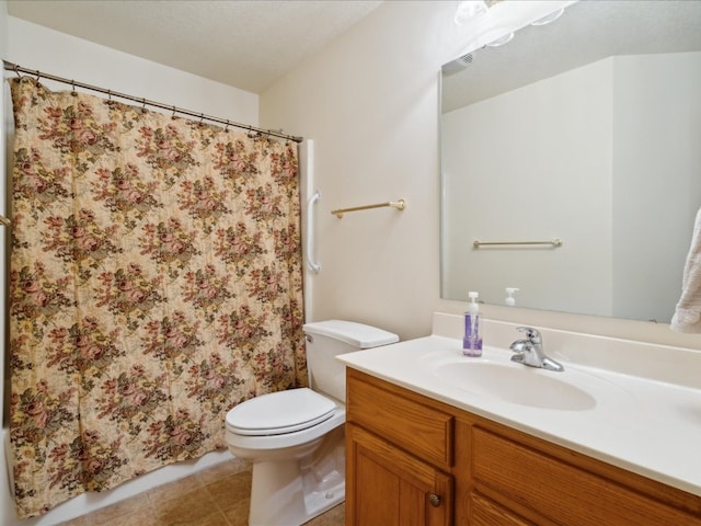 bathroom with tile patterned floors, vanity, a textured ceiling, and toilet