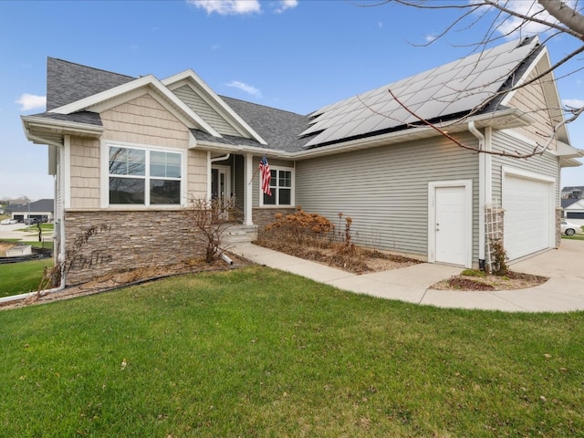 view of front of house with a front yard, solar panels, and a garage