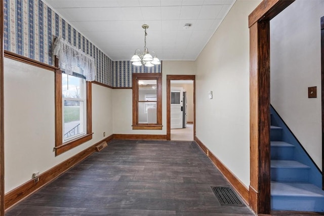 interior space featuring dark wood-type flooring and an inviting chandelier